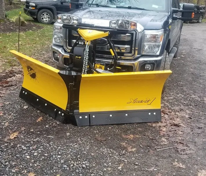 RB Landscaping pickup truck fitted with a yellow snow plow